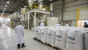 A paint production facility with titanium dioxide powder and workers